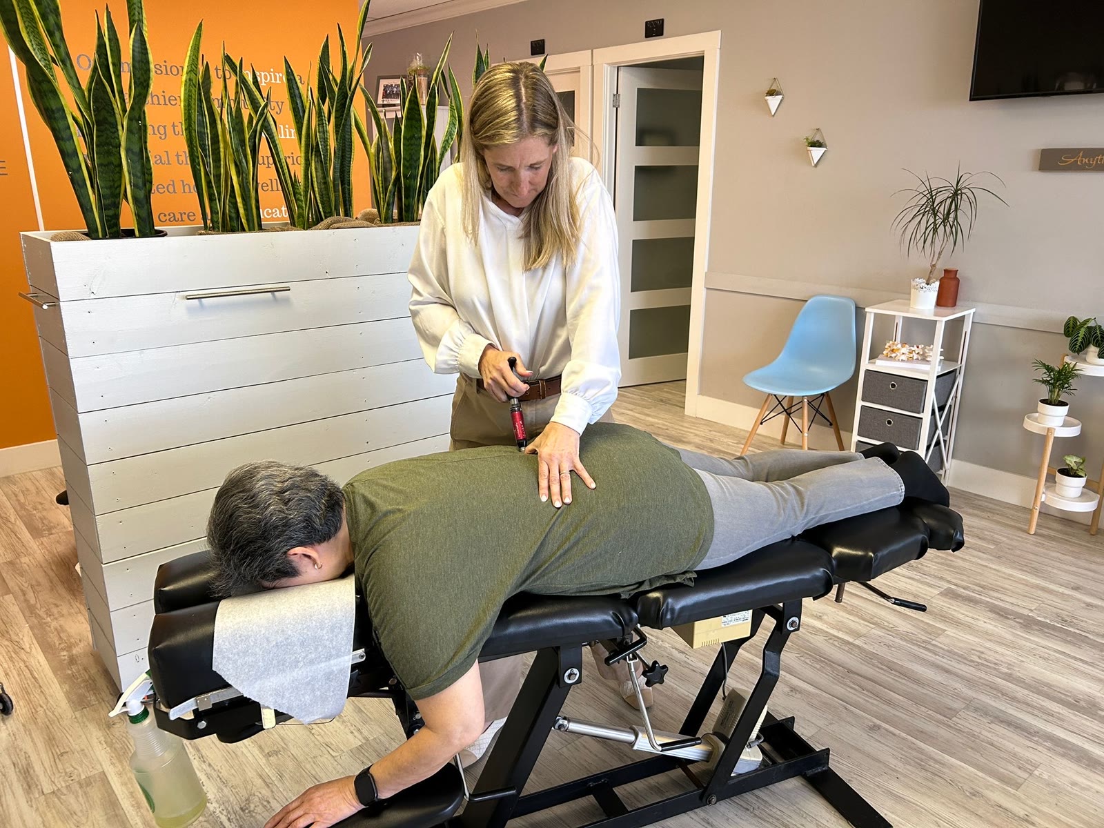 An instrument-assisted chiropractic adjustment at Synergy Chiropractic