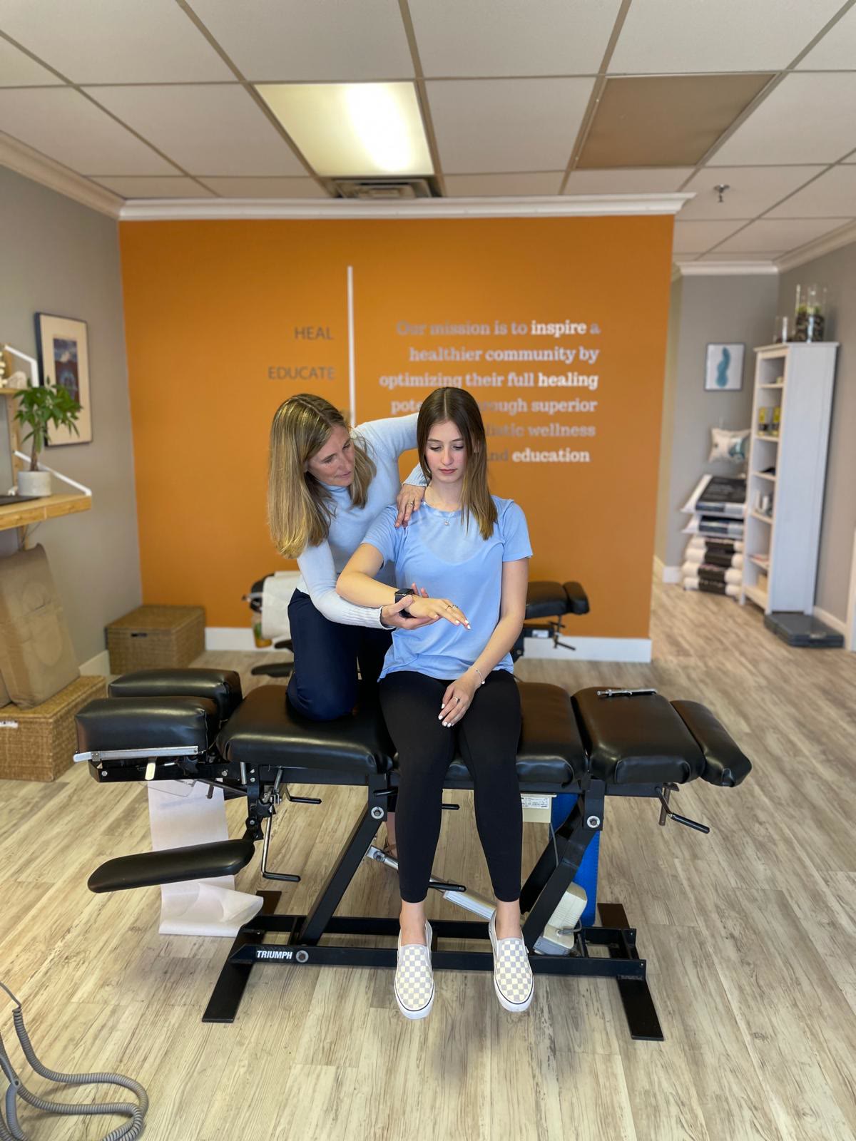 A chiropractic assessment in the treatment room at Synergy Chiropractic in Markham