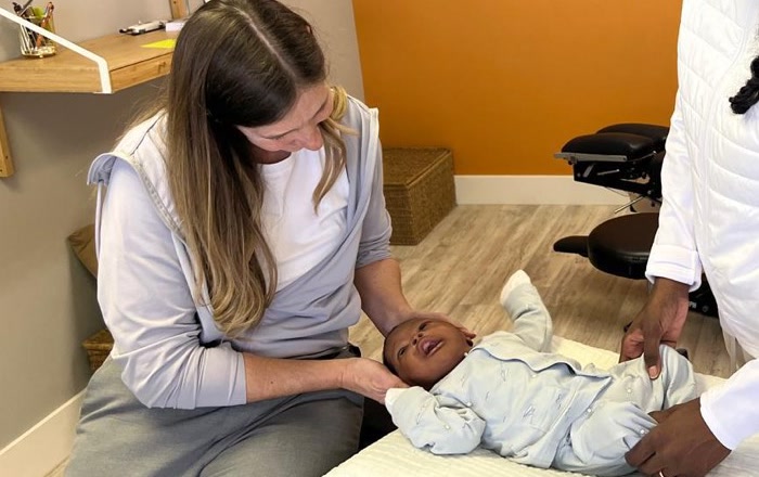 Dr. Shelley Seguin giving an infant a gentle chiropractic adjustment at Synergy